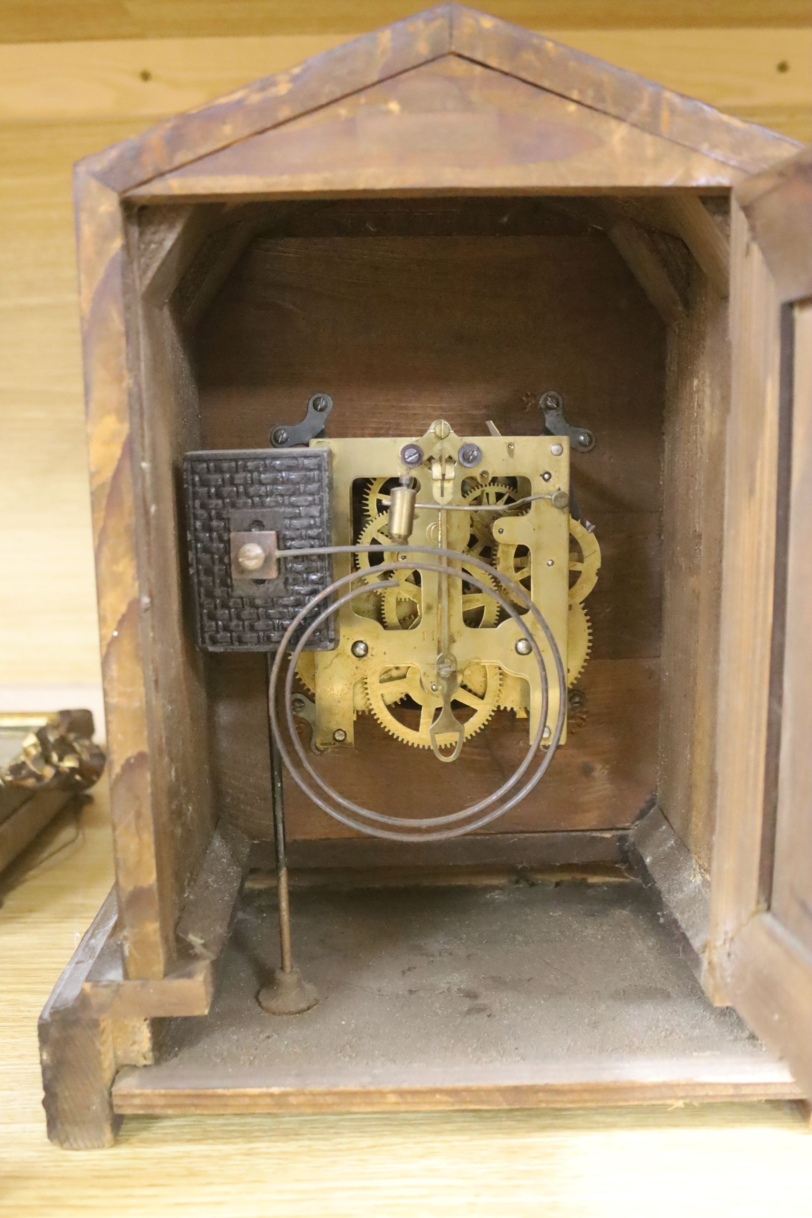 A slate mantel clock with lion surmount and a mahogany mantel clock